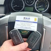 2 car keys and business card with contact details