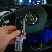 Spatre key made for Skoda Octavia showing new key, and steering wheel with Skoda logo