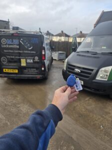 New ford transit van key with MJS Auto Locksmith key tag attached and mobile sign written van in background