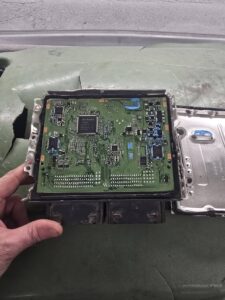 internal components of vehicle ecu laid on green surface